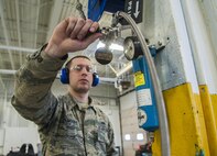 Senior Airman Daniel Moore, 5th Maintenance Squadron hydraulics journeyman, turns off an air compression machine at Minot Air Force Base, N.D., Feb. 23, 2017. After inspecting the hoses, pneudraulics Airmen blow air through them to ensure each hose is completely dry from water. (U.S. Air Force photo/Airman 1st Class Jonathan McElderry)