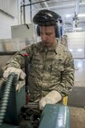 Senior Airman Daniel Moore, 5th Maintenance Squadron hydraulics journeyman, cuts a teflon hose at Minot Air Force Base, N.D., Feb. 23, 2017. The pneudraulics shop is responsible for inspecting and maintaining all Minot AFB B-52H Stratofortresses’ hydraulic systems. (U.S. Air Force photo/Airman 1st Class Jonathan McElderry)