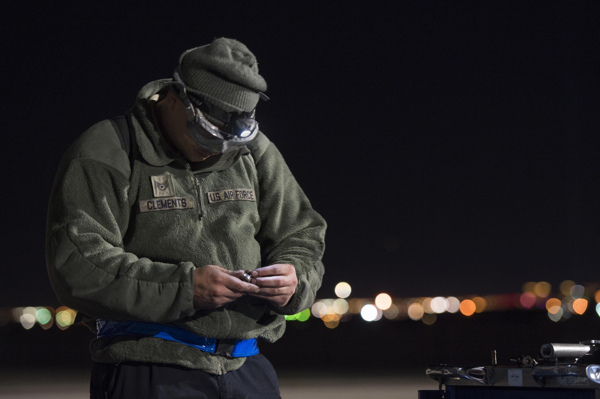 U.S. Air Force Staff Sgt. Samuel Clements, 20th Aircraft Maintenance Squadron avionics specialist, Shaw Air Force Base, S.C. uses light from a headlamp to select an appropriate tool while conducting repairs on an F-16CM Fighting Falcon in support of Red Flag 17-2 at Nellis AFB, Nev., Feb. 28, 2017. Red Flag provides an opportunity for 20th Fighter Wing aircrew and maintainers to enhance their tactical operational skills by exposing them to a simulated combat environment. (U.S. Air Force photo by Senior Airman Zade Vadnais)