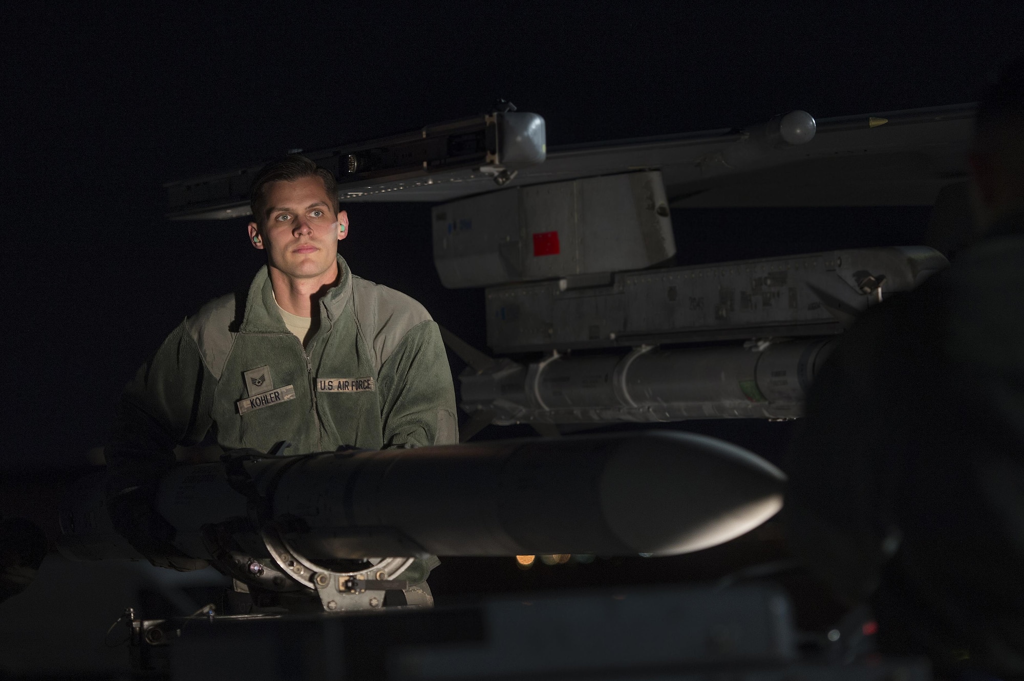 U.S. Air Force Staff Sgt. Jeffrey Kohler, 20th Aircraft Maintenance Squadron weapons load crew member, Shaw Air Force Base, S.C. removes an AIM-120 advanced medium-range air-to-air missile from an F-16CM Fighting Falcon in support of Red Flag 17-2 at Nellis Air Force Base, Nev., Feb. 28, 2017. While participating in Red Flag, weapons load crew members have the opportunity to work with live munitions as opposed to the dummy munitions they practice with at Shaw. (U.S. Air Force photo by Senior Airman Zade Vadnais)