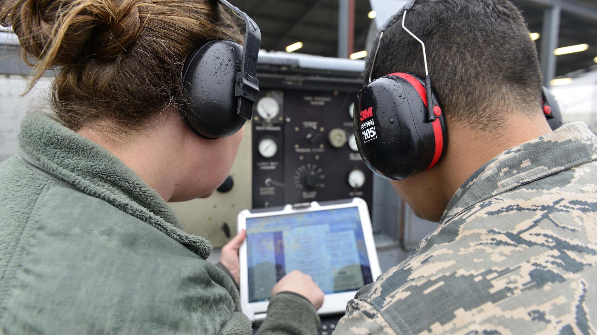 Tech. Sgt. Sabrina Aviles, 372nd Training Squadron production superintendent and Aerospace Ground Equipment instructor, and Senior Airman David Castillo-Collazo, 31st Maintenance Squadron AGE journeyman, troubleshoot a temperature regulator, Jan. 31, 2017, at Aviano Air Base, Italy. The routine systems check presented a problem that Castillo-Collazo found and fixed. (U.S. Air Force photo by Senior Airman Cary Smith)