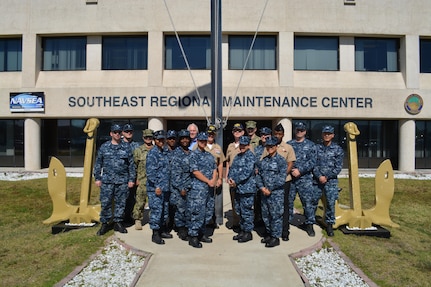 Capt. Dave Gombas, Commanding Officer (back row, center right); Capt. Gary Martin (back row, center left), Executive Officer and Bob Wright (back row, center left), Executive Director at Southeast Regional Maintenance Center (SERMC) are surrounded by Navy Counselor Chief Shanika Jones (4th from left) and a few of the SERMC Sailors who reenlisted during Fiscal Year 2016. SERMC was recognized for successful Sailor programs that form the foundation of a successful retention effort, earning the coveted “Golden Anchors” award.