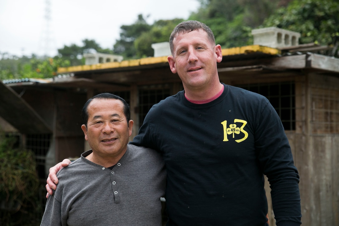 Marine Corps Gunnery Sgt. Todd Groves and Bokusei Kinjo pose for a photo at Kinjo’s farm near Camp Hansen, Okinawa, Japan, Feb. 23, 2017. Groves has helped take care of the land and the animals on Kinjo’s farm for two years. Marine Corps photo by Lance Cpl. Bernadette Wildes