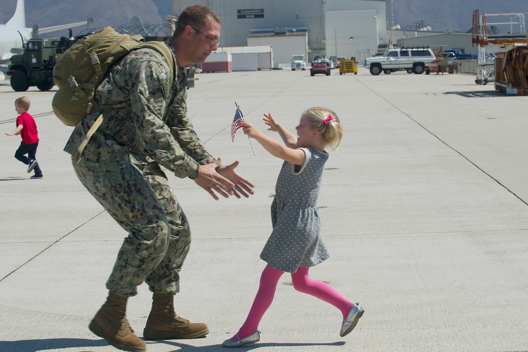 A Navy Seabee greets his child at Naval Base Ventura County, Calif., Sept. 21, 2016. The Seabees returned from a six-month deployment to the Pacific Command area of operations. Navy photo by Petty Officer 1st Class Michael Gomez