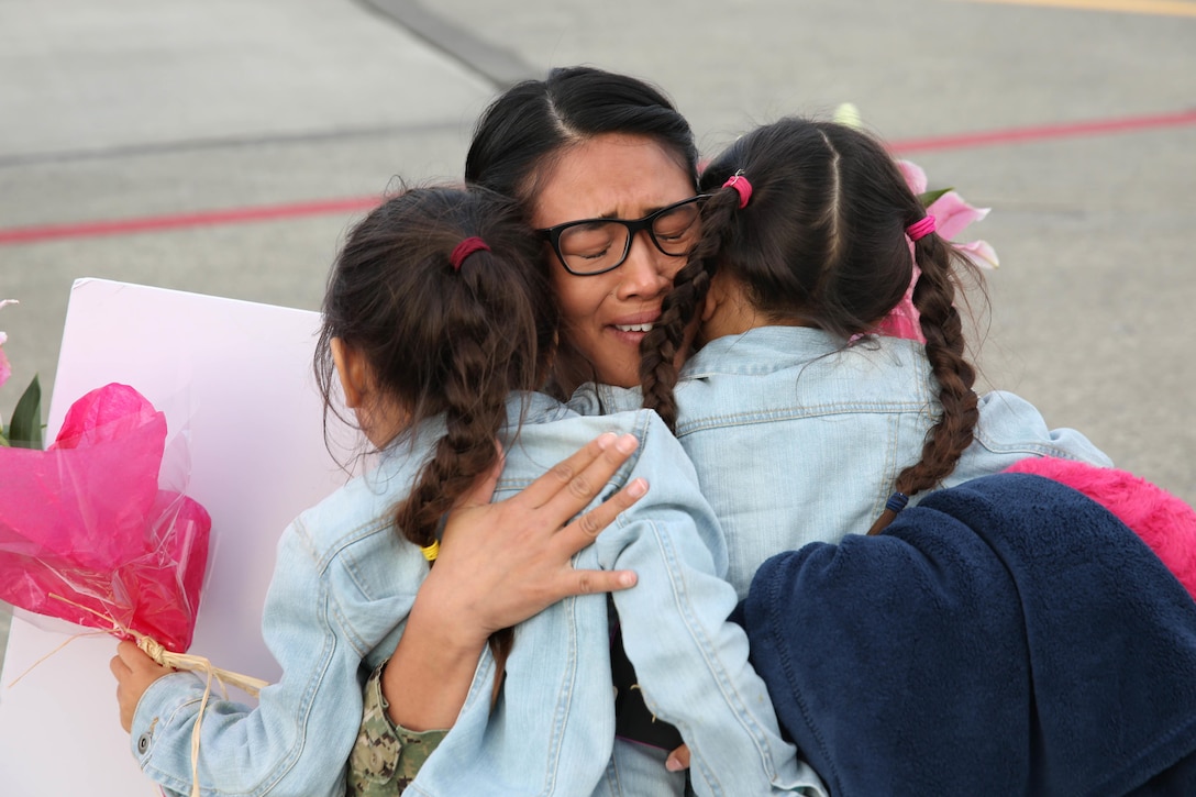 Navy Petty Officer 1st Class Jamaica Francia hugs her daughters at Naval Air Station Whidbey Island in Oak Harbor, Wash., Sept. 29, 2016, after returning from deployment. Navy photo by Petty Officer 2nd Class John Hetherington