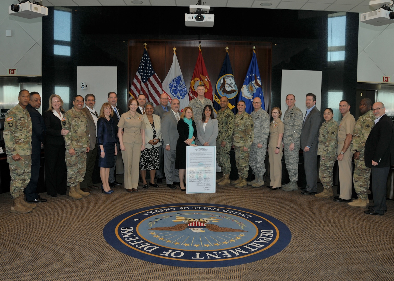 Andrea Verdino (front left) and Renée Ferranti (front right) join Busch and other senior leaders for a group photo. 