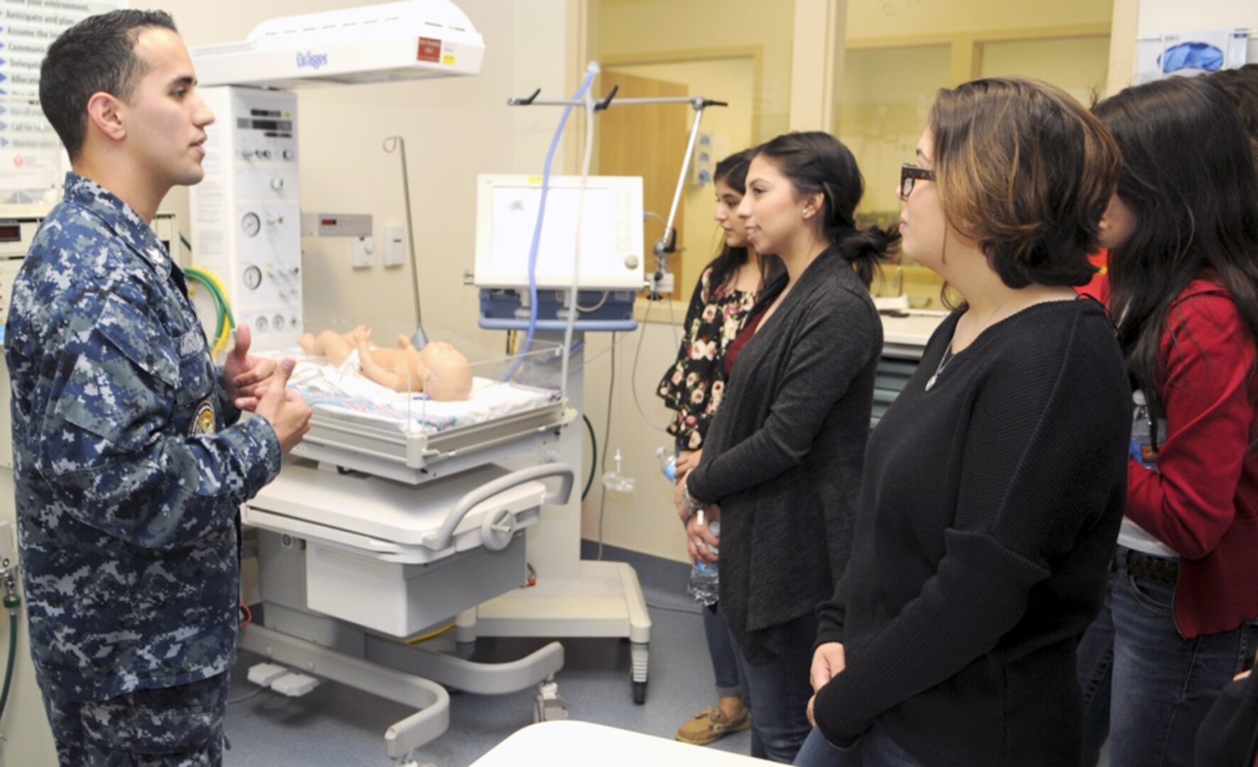 Petty Officer 2nd Class Christian Miranda, a respiratory therapist instructor at the Medical Education and Training Campus, talks to students from John Marshall High School about respiratory therapists' job in newborn intensive care units during a tour of METC at Joint Base San Antonio-Fort Sam Houston March 2. The tour was conducted by METC's Navy service component, Navy Medicine Training Support Center, as part of their Science, Technology, Engineering and Mathematics, or STEM, efforts.