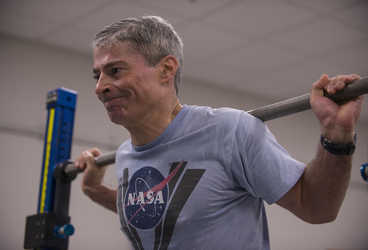 Mark Vande Hei, a retired Army colonel, trains on the advanced resistive exercise device, which astronauts use to stop muscle loss while being weightless in space, at Johnson Space Center in Houston, March 1, 2017. Astronauts can simulate free-weight exercises in normal gravity by using the device's adjustable resistance piston-driven vacuum cylinders to get a load of up to 600 pounds. DoD photo by Sean Kimmons