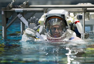 Mark Vande Hei, a retired Army colonel, waves as he is lowered into NASA's Neutral Buoyancy Laboratory pool near Johnson Space Center in Houston as part of training, March 1, 2017. The pool is one of the world's largest at 202 feet long and 40 feet deep, and is big enough to hold a replica of the International Space Station. Vande Hei is preparing for his first space mission, which is scheduled for mid-September. DoD photo by Sean Kimmons