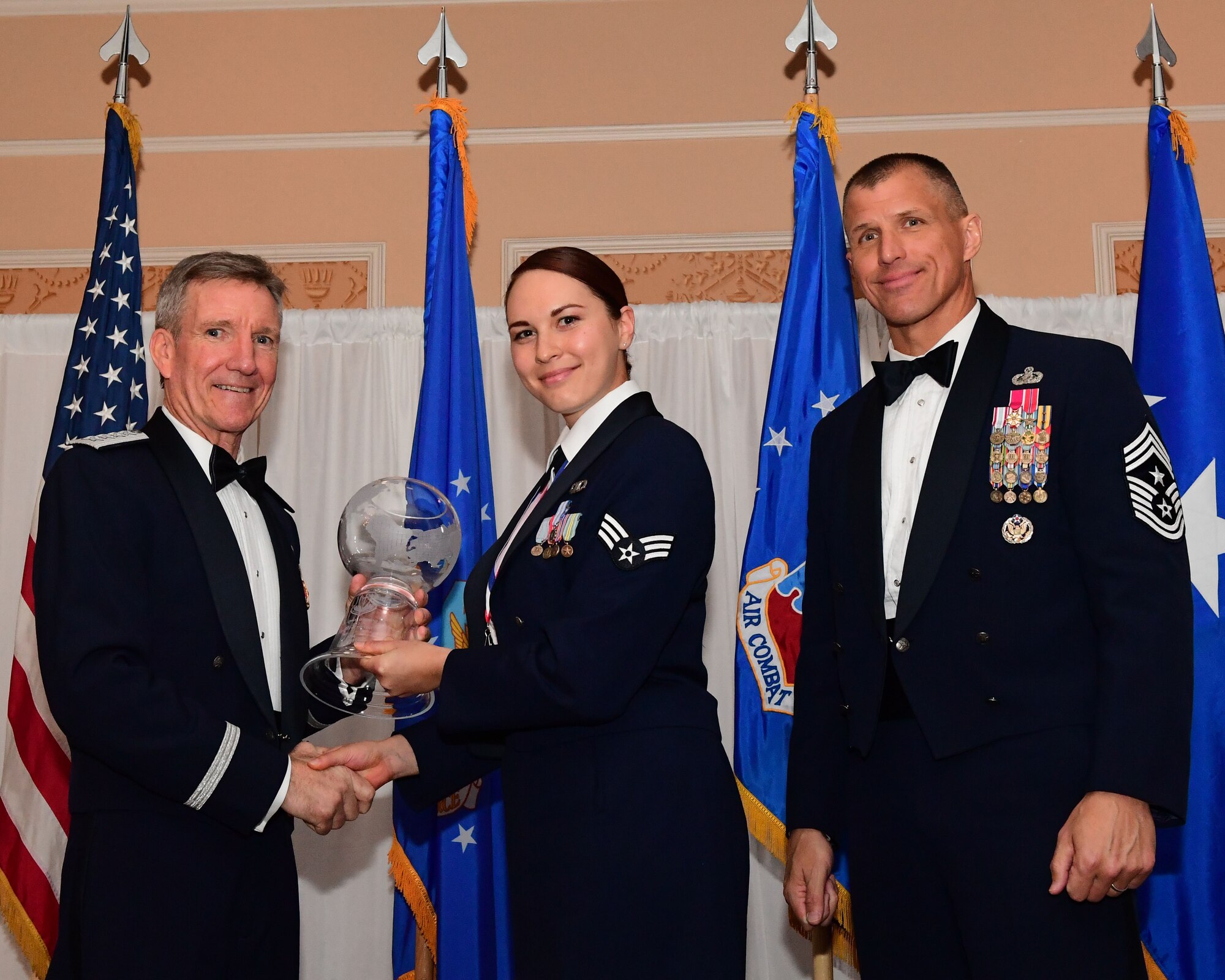 Gen. Hawk Carlisle, commander, Air Combat Command presents an award to Senior Airman Liae Hess, 355th Fighter Wing air traffic controller, Davis-Monthan Air Force Base, Arizona, as Chief Master Sgt. Steve McDonald, command chief, ACC observes during the 2017 Outstanding Airmen of the Year banquet at the Bayview Community Center at  Langley AFB, Virginia, March 8, 2017. The award recognizes 12 outstanding enlisted service members for superior leadership, job performance, community involvement and personal achievements. (U.S. Air Force photo by Staff Sgt. Nick Wilson)