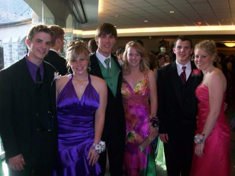 Now Senior Airman Alex Greenawalt (far left), a 49th Civil Engineer Squadron explosive ordnance disposal technician and now Airman 1st Class Alana Greenawalt (second from left), a 635th Materiel Maintenance Group power production technician, pose during their May 2010 senior prom with a group of friends, prior to joining the Air Force (Courtesy photo)