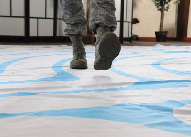 Staff Sgt. Derrick Lehner, 9th Reconnaissance Wing chaplain assistant and noncommissioned officer in charge  of Airman community development walks the labyrinth at the Valley Chapel, March 7, 2017, at Beale Air Force Base, California. A labyrinth may be used as a from of prayerful movement or meditation for religious and non-religious purposes. (U.S. Air Force photo/Airman 1st Class Aubrey Barringer)