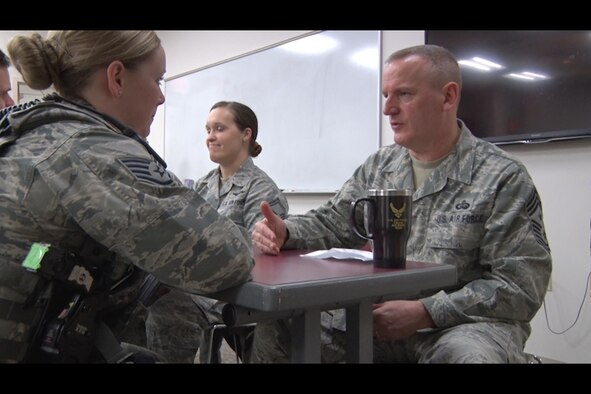 Staff Sgt. Kelsey Hannafin, 157th Security Forces Squadron member, talks with Chief Master Sgt. James Lawrence, 157th Air Refueling Wing Command Chief Master Sergeant, during the speed- mentoring event at Pease Air National Guard Base, N.H. Feb. 5. The event was created as an opportunity for NCOs to build professional relationships and aid their military career. (N.H. Air National Guard still from video by Tech. Sgt. Erica Rowe)