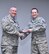 The 932nd Airlift Wing commander, Col. Jonathan Philebaum, smiles as he presents the competitive Noncommissioned Officer of the Fourth Quarter award to Staff Sgt. John Wood for his impressive work in the 932nd Medical Squadron. The event took place at commander's call March 4, 2017, on Scott Air Force Base, near Belleville, Ill. The 932nd Medical Group is part of 22nd Air Force, Air Force Reserve Command. (U.S. Air Force photo by Tech. Sgt. Christopher Parr) 