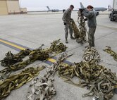 Joint Records Team (JRT) members prepare to receive presidential materials outside of a hangar on Joint Base Andrews, Md., Feb. 14, 2017. JRT members included Airmen assigned to the Air Force District of Washington (AFDW) and Soldiers from the U.S. Army's 3rd Infantry Division "The Old Guard" worked in concert with Presidential Material Handlers from the National Archives and Records Management (NARA) over several months to ensure the safe movement of the records and artifacts gathered during the eight years of President Obama's administration. The JRT was tasked with helping to inventory, prepare for shipping, palletize and load several tons of paper records, terabytes of electronic records, and thousands of artifacts. Along with several truck shipments the bulk of the materials were loaded onto and Air Force C-5 Galaxy cargo aircraft brought in from Dover Air Force Base, Del., and were then flown to Chicago, Ill., where they were placed in secure storage until completion of Obama's Presidential Library. The library is part of the presidential library system, which is administered by the National Archives and Records Administration. (U.S. Air Force photo/Jim Varhegyi) (released)