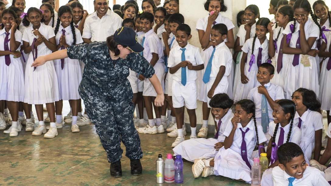 Navy Petty Officer 3rd Class Emily Kershaw performs with school children during Pacific Partnership 2017, a humanitarian relief exercise, in Hambantota, Sri Lanka, March 8, 2017. The exercise aims to enhance regional coordination in areas such as medical readiness and preparedness for manmade and natural disasters. Kershaw is a musician assigned to the U.S. 7th Fleet Band, Far East Edition. Navy photo by Petty Officer 2nd Class Joshua Fulton