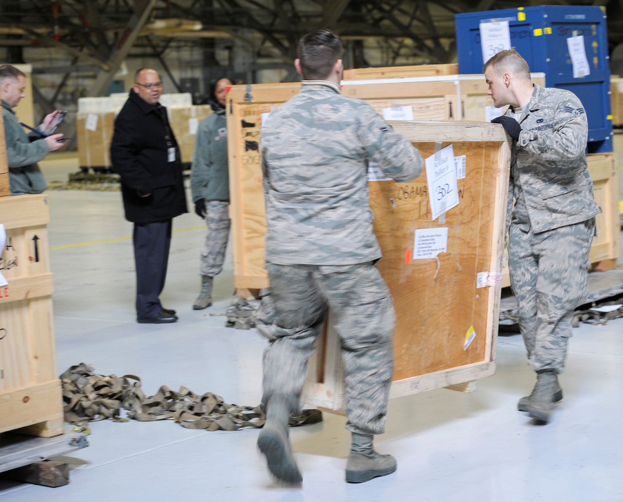 The Joint Records Team (JRT) made up of Airmen assigned to the Air Force District of Washington (AFDW) and Soldiers from the U.S. Army's 3rd Infantry Division "The Old Guard" worked in concert with Presidential Material Handlers from the National Archives and Records Management (NARA) over several months to ensure the safe movement of the records and artifacts gathered during the eight years of President Obama's administration. The JRT was tasked with helping to inventory, prepare for shipping, palletize and load several tons of paper records, terabytes of electronic records, and thousands of artifacts. Along with several truck shipments the bulk of the materials were loaded onto and Air Force C-5 Galaxy cargo aircraft brought in from Dover Air Force Base, Del., and were then flown to Chicago, Ill., where they were placed in secure storage until completion of Obama's Presidential Library. The library is part of the presidential library system, which is administered by the National Archives and Records Administration. (U.S. Air Force photo/Jim Varhegyi) (released)