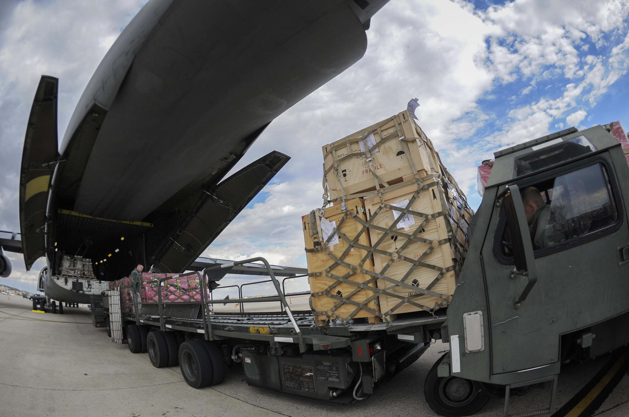 Presidential materials are loaded onto a C-5 Galaxy cargo aircraft at Joint Base Andrews, Md., Feb. 15, 2017. The Joint Records Team (JRT) made up of Airmen assigned to the Air Force District of Washington (AFDW) and Soldiers from the U.S. Army's 3rd Infantry Division "The Old Guard" worked in concert with Presidential Material Handlers from the National Archives and Records Management (NARA) over several months to ensure the safe movement of the records and artifacts gathered during the eight years of President Obama's administration. The JRT was tasked with helping to inventory, prepare for shipping, palletize and load several tons of paper records, terabytes of electronic records, and thousands of artifacts. Along with several truck shipments the bulk of the materials were loaded onto and Air Force C-5 Galaxy cargo aircraft brought in from Dover Air Force Base, Del., and were then flown to Chicago, Ill., where they were placed in secure storage until completion of Obama's Presidential Library. The library is part of the presidential library system, which is administered by the National Archives and Records Administration. (U.S. Air Force photo/Jim Varhegyi) (released) 