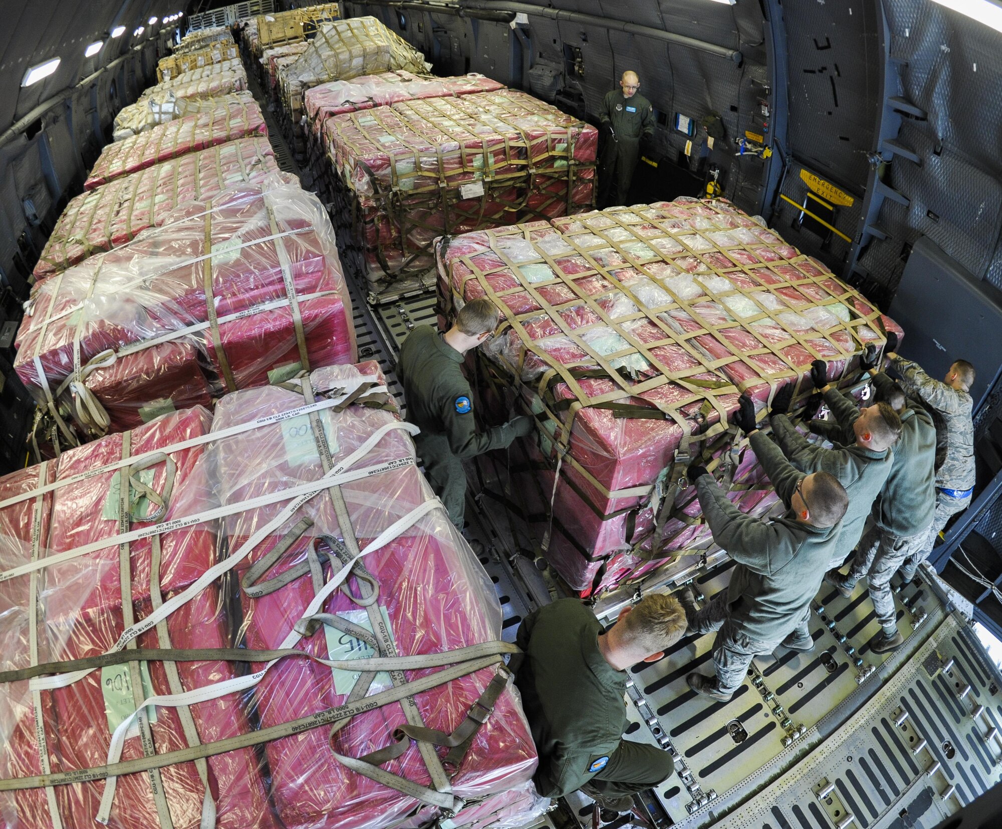 Presidential materials are loaded onto a C-5 Galaxy cargo aircraft at Joint Base Andrews, Md., Feb. 15, 2017. The Joint Records Team (JRT) made up of Airmen assigned to the Air Force District of Washington (AFDW) and Soldiers from the U.S. Army's 3rd Infantry Division "The Old Guard" worked in concert with Presidential Material Handlers from the National Archives and Records Management (NARA) over several months to ensure the safe movement of the records and artifacts gathered during the eight years of President Obama's administration. The JRT was tasked with helping to inventory, prepare for shipping, palletize and load several tons of paper records, terabytes of electronic records, and thousands of artifacts. Along with several truck shipments the bulk of the materials were loaded onto and Air Force C-5 Galaxy cargo aircraft brought in from Dover Air Force Base, Del., and were then flown to Chicago, Ill., where they were placed in secure storage until completion of Obama's Presidential Library. The library is part of the presidential library system, which is administered by the National Archives and Records Administration. (U.S. Air Force photo/Jim Varhegyi) (released) 