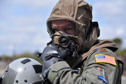 Major Chris De Winnie, 16th Airlift Squadron pilot, wears chemical, biological, radiological and nuclear (CBRN) gear during Exercise Bonny Jack 2017 on the flightline here, March 8, 2017. Exercise Bonny Jack 2017 is a three-part readiness exercise for the 437th Airlift Wing. The first major event in the exercise was a two-day mobility exercise March 1 and 2, followed by a CBRN exercise. Bonny Jack 2017 will conclude with a large-formation exercise in May. 