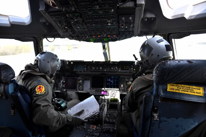 Capt. Manny Buelina, left, and Major Chris De Winnie, right, 16th Airlift Squadron pilots, perform preflight checks during Exercise Bonny Jack 2017 on the flightline here, March 8, 2017. Exercise Bonny Jack 2017 is a three-part readiness exercise for the 437th Airlift Wing. The first major event in the exercise was a two-day mobility exercise March 1 and 2, followed by a CBRN exercise. Bonny Jack 2017 will conclude with a large-formation exercise in May.  