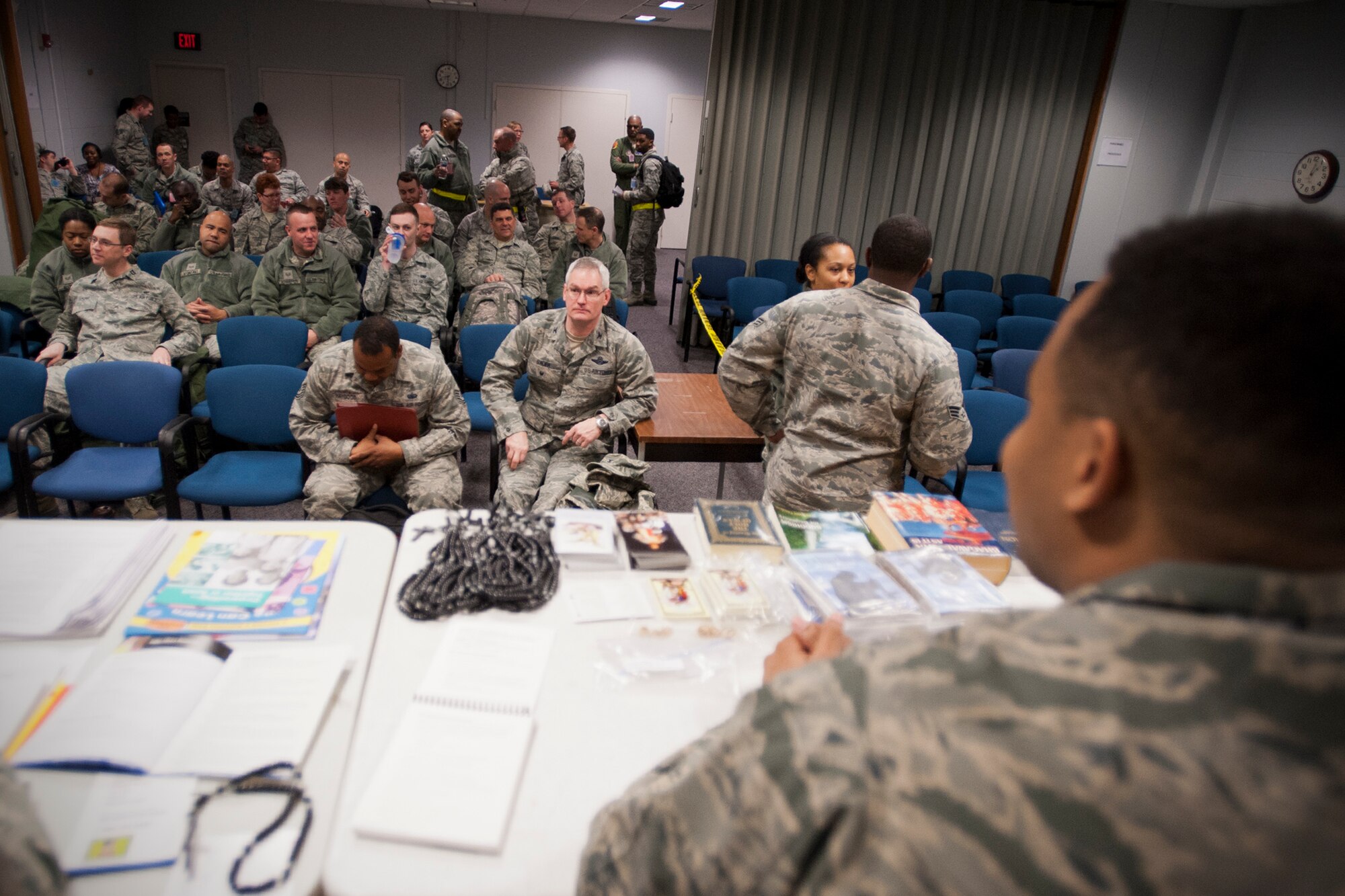 Members of the 459th Air Refueling Wing wait to cycle through a simulated deployment line as part of an exercise at Joint Base Andrews, Maryland, March 5, 2017. Deployers prepared their mobility paperwork and bags prior to visiting Eligibility, Finance, Airman and Family Readiness, Chaplaincy, Legal, Medical and Passenger Manifest stations. (U.S. Air Force photo/Tech. Sgt. Kat Justen)