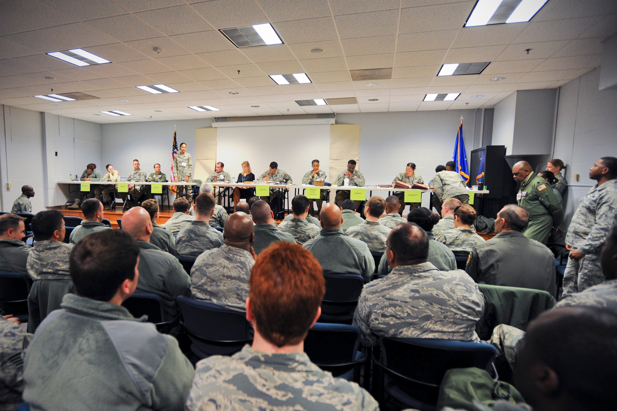 Members of the 459th Air Refueling Wing wait to cycle through a simulated deployment line as part of an exercise at Joint Base Andrews, Maryland, March 5, 2017. Deployers prepared their mobility paperwork and bags prior to visiting Eligibility, Finance, Airman and Family Readiness, Chaplaincy, Legal, Medical and Passenger Manifest stations. (U.S. Air Force photo/Tech. Sgt. Kat Justen)