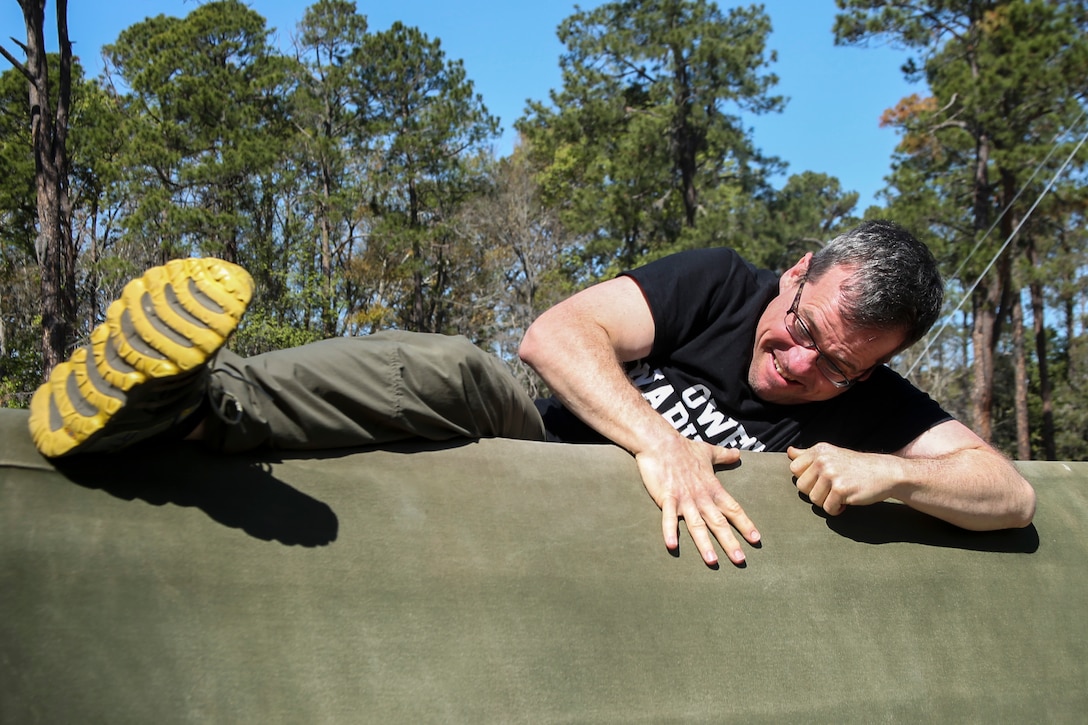 James Rumbaugh a school counselor at Charles D. Owen High School participates in the confidence course during the Recruiting Station Atlanta/Columbia Educators Workshop aboard Marine Corps Recruit Depot Parris Island, South Carolina, Mar. 9, 2017. These participants come from both Recruiting Station Atlanta and Columbia to experience the Educators Workshop. The Educators Workshop provides an opportunity for educators to have an inside look at the Marine Corps to better inform students in their respective schools. (U.S. Marine Corps photo by Lance Cpl. Jack A. E. Rigsby/Released)