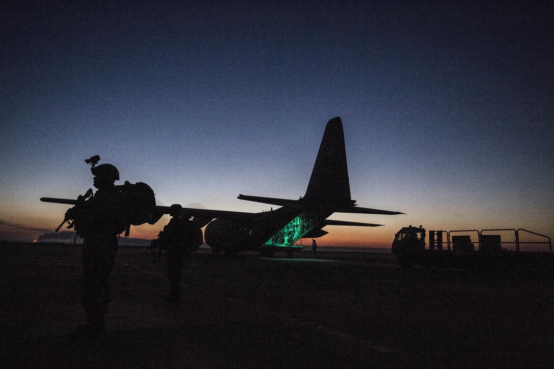An airman secures the area around a C-130 Hercules while crews load cargo to support a Combined Joint Task Force Operation Inherent Resolve mission from an undisclosed location, March 7, 2017. The airman is assigned to the 379th Expeditionary Security Forces Squadron Fly Away Security Team. Air Force photo by Staff Sgt. Matthew B. Fredericks