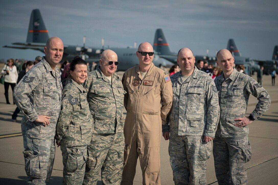 U.S. Air Force Capt. Michael Filipek, center, a C-130 Hercules pilot with the 169th Airlift Squadron, Illinois Air National Guard, poses with family members after returning to Peoria, Ill., from an overseas deployment March 5, 2017. Filipek and more than 100 other 182nd Airlift Wing Airmen deployed to an undisclosed location in Southwest Asia in support of Operation Freedom’s Sentinel. (U.S. Air National Guard photo by Tech. Sgt. Lealan Buehrer)
