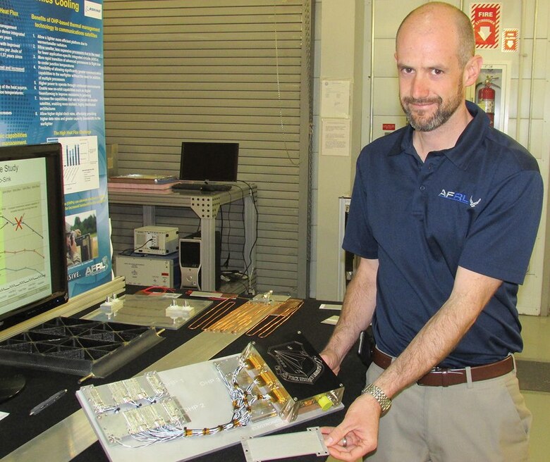 Brent Taft, Air Force Research Laboratory Space Vehicles Directorate thermal systems lead, shows an oscillating heat pipe system designed for an upcoming flight experiment, top, and an oscillating heat pipe by itself. The technology cools electronics systems and is nearing commercialization.