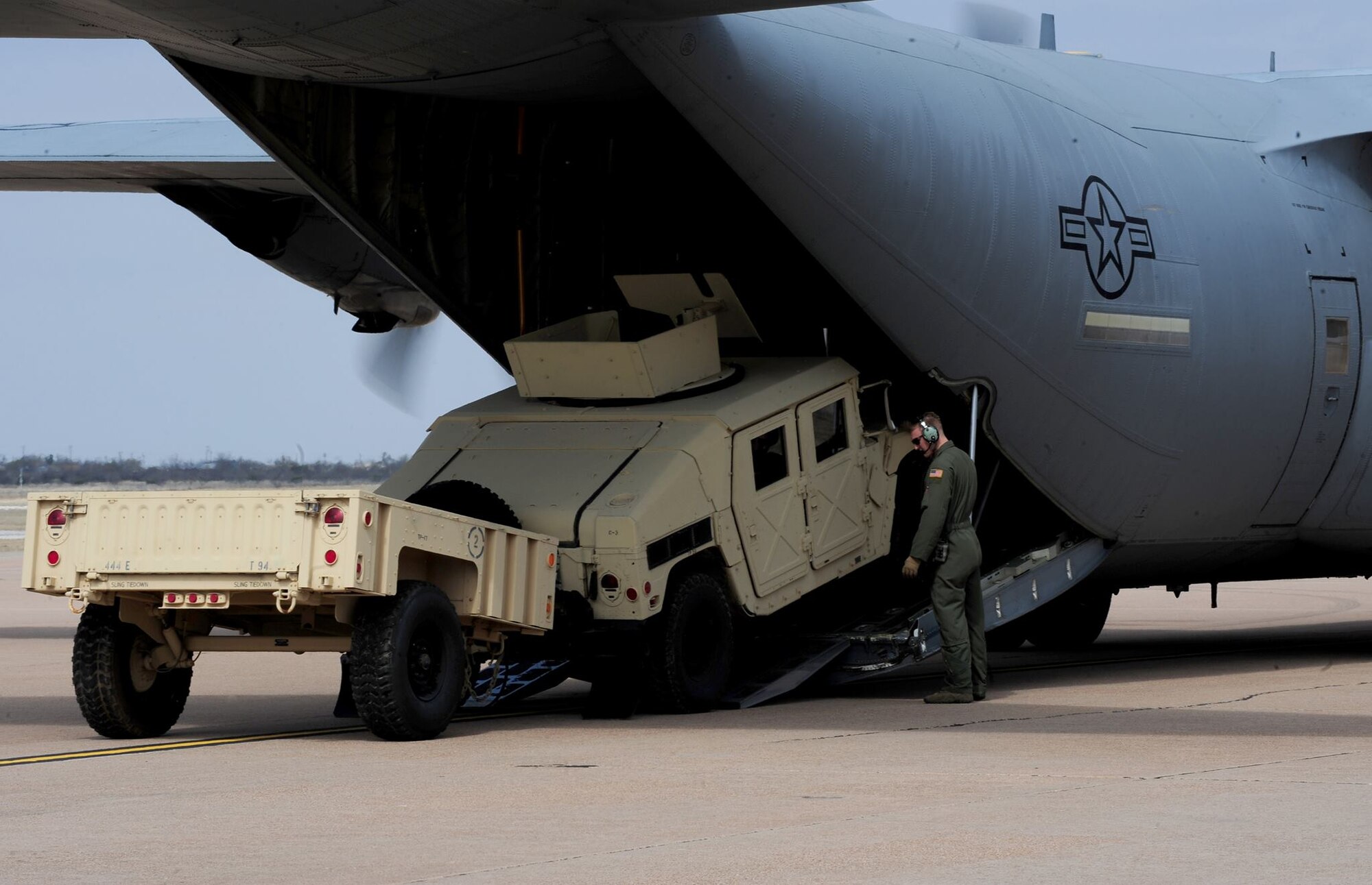 U.S. Air Force Staff Sgt. Cody Olson, 39th Airlift Squadron loadmaster, helps guide the driver of a convoy vehicle onto a C-130J Super Hercules at Dyess Air Force Base, Texas, March 8, 2017. Throughout the 317th Airlift Group Rodeo competition, each team was faced with a series of tactical events such as combat on and off-loading, airdrops and assault landings. (U.S. Air Force photo by Airman 1st Class April Lancto)