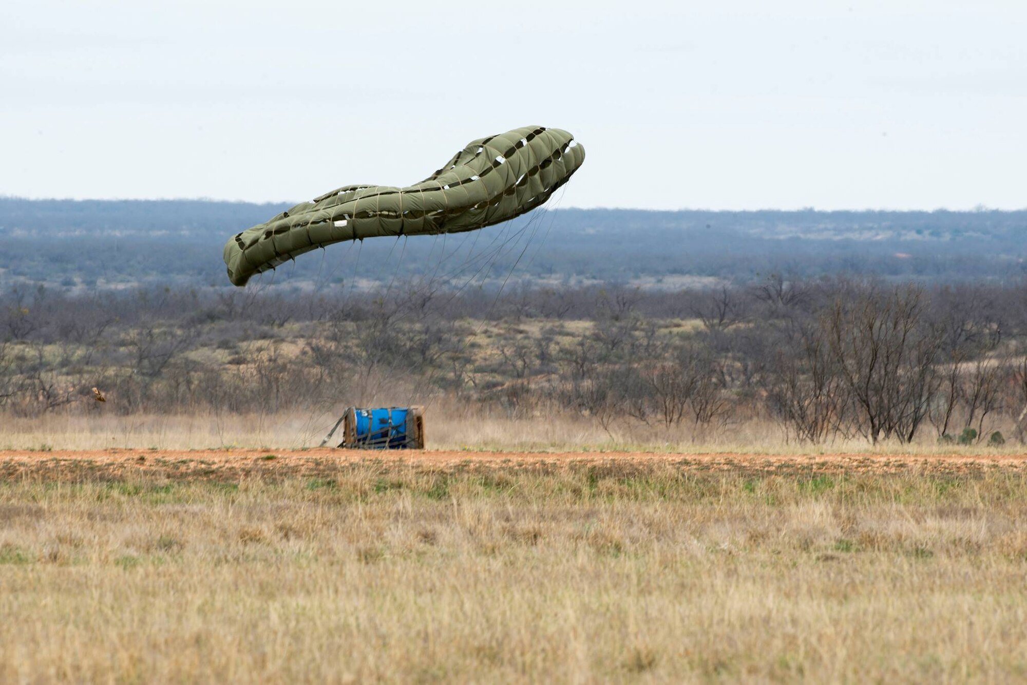 Members from the 39th Airlift Squadron, 40th AS and 317th Operations Support Squadron drop cargo during a competition March, 8, 2017, at Bronte, Texas. The Rodeo is a friendly competition between the 39th AS, 40th AS and 317th OSS, who compete in different events such as loading, ground and flying operations which earns them bragging rights for the year. (U.S. Air Force photo by Airman 1st Class Austin Mayfield)