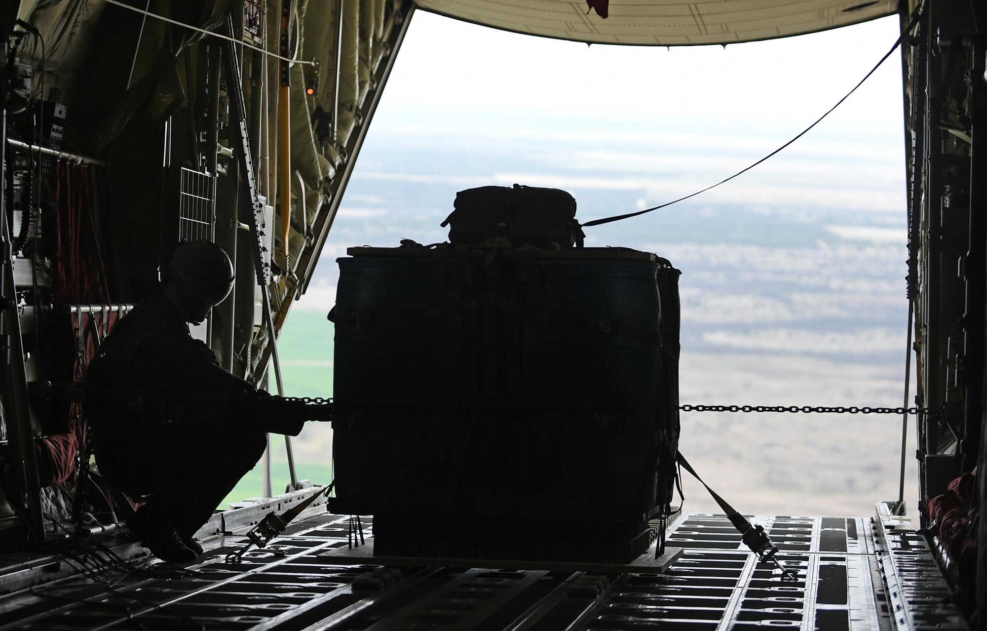 U.S. Air Force Staff Sgt. Cody Olson, a 39th Airlift Squadron loadmaster, prepares to airdrop a pallet of barrels on a marked target March 8, 2017, near Bronte, Texas. The 317th Airlift Group held a tactical airlift competition to test and improve combat tactics in a competitive environment with a split focus on pilot and loadmaster skills. (U.S. Air Force photo by Airman 1st Class Emily Copeland)