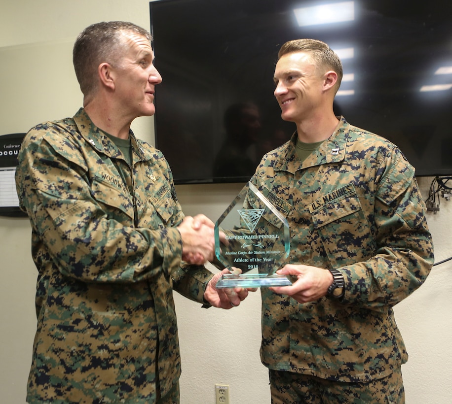 Col. Jason Woodworth, commanding officer of Marine Corps Air Station Miramar, Calif., presents the MCAS Miramar’s Athlete of the Year trophy to Capt. E. Thomas “Tom” Pinnell III, assistant judge advocate with Marine Wing Headquarters Squadron (MWHS) 3, during a ceremony at MCAS Miramar, March 7. Pinnell competed in the 2017 Conseil International du Sport Militaire (CISM) Military World Cup and received MCAS Miramar’s Athlete of the Year award twice. (U.S. Marine Corps photo by Cpl. Harley Robinson/Released)