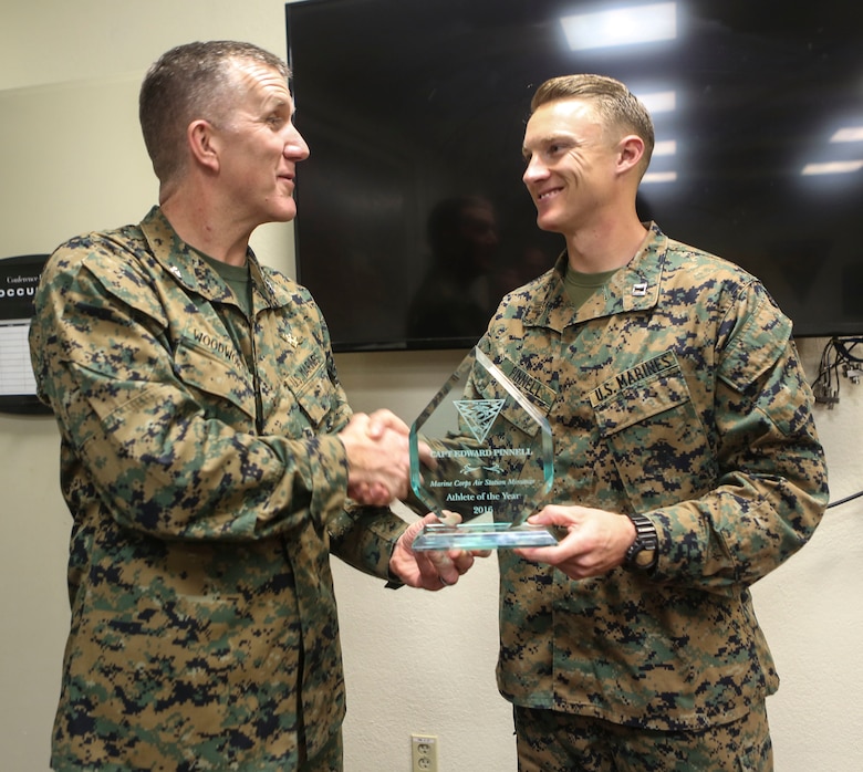 Col. Jason Woodworth, commanding officer of Marine Corps Air Station Miramar, Calif., presents the MCAS Miramar’s Athlete of the Year trophy to Capt. E. Thomas “Tom” Pinnell III, assistant judge advocate with Marine Wing Headquarters Squadron (MWHS) 3, during a ceremony at MCAS Miramar, March 7. Pinnell competed in the 2017 Conseil International du Sport Militaire (CISM) Military World Cup and received MCAS Miramar’s Athlete of the Year award twice. (U.S. Marine Corps photo by Cpl. Harley Robinson/Released)