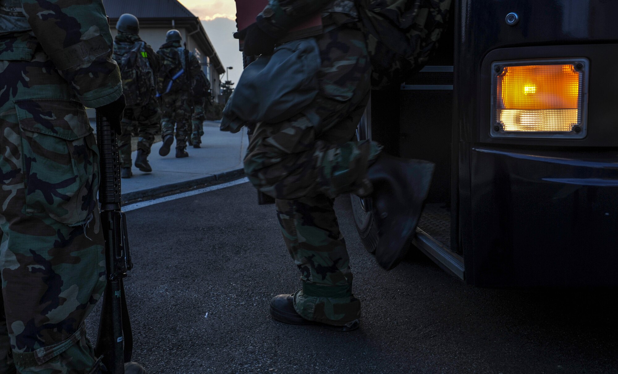 U.S. Air Force members step off a bus as they form a line as the Wolf Pack tests the ability to accept follow-on forces during exercise Beverly Pack 17-2, a no-notice training exercise at Kunsan Air Base, Republic of Korea, March 8, 2017. Kunsan airmen provide combat capabilities alongside Republic of Korea partners by participating in training, inspections and exercises throughout the year to enhance communication and interoperability between military forces so they are prepared to fight as a combined force. (U.S. Air Force photo by Senior Airman Colville McFee/Released)