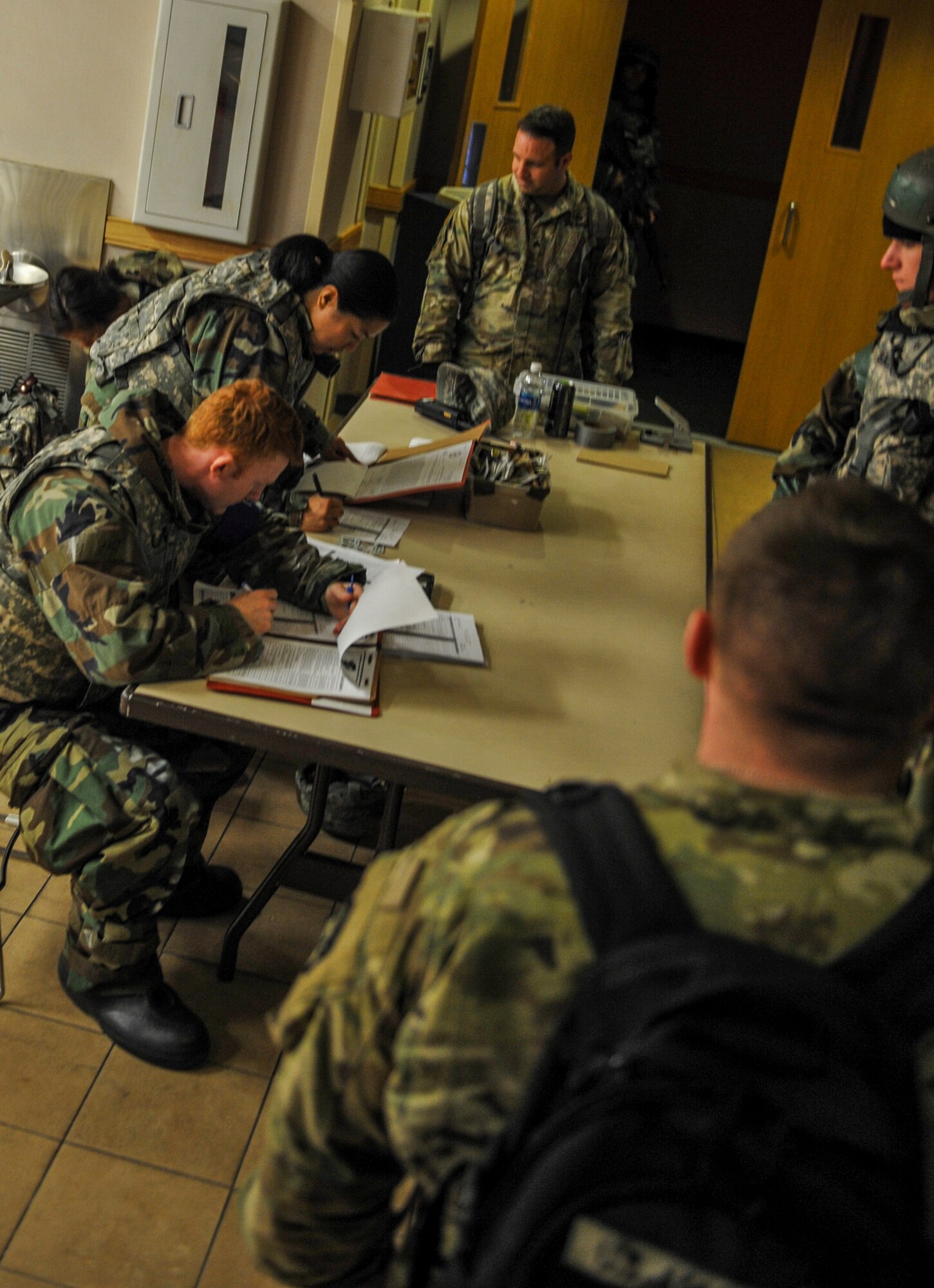 U.S. Air Force Senior Airman Dylan Williams and Staff Sgt. Toni Somera, 8th Force Support Squadron force management personalists, input information as they accept follow-on forces during exercise Beverly Pack 17-2, a no-notice training exercise at Kunsan Air Base, Republic of Korea, March 8, 2017.  Kunsan airmen provide combat capabilities alongside Republic of Korea partners by participating in training, inspections and exercises throughout the year to enhance communication and interoperability between military forces so they are prepared to fight as a combined force. (U.S. Air Force photo by Senior Airman Colville McFee/Released)