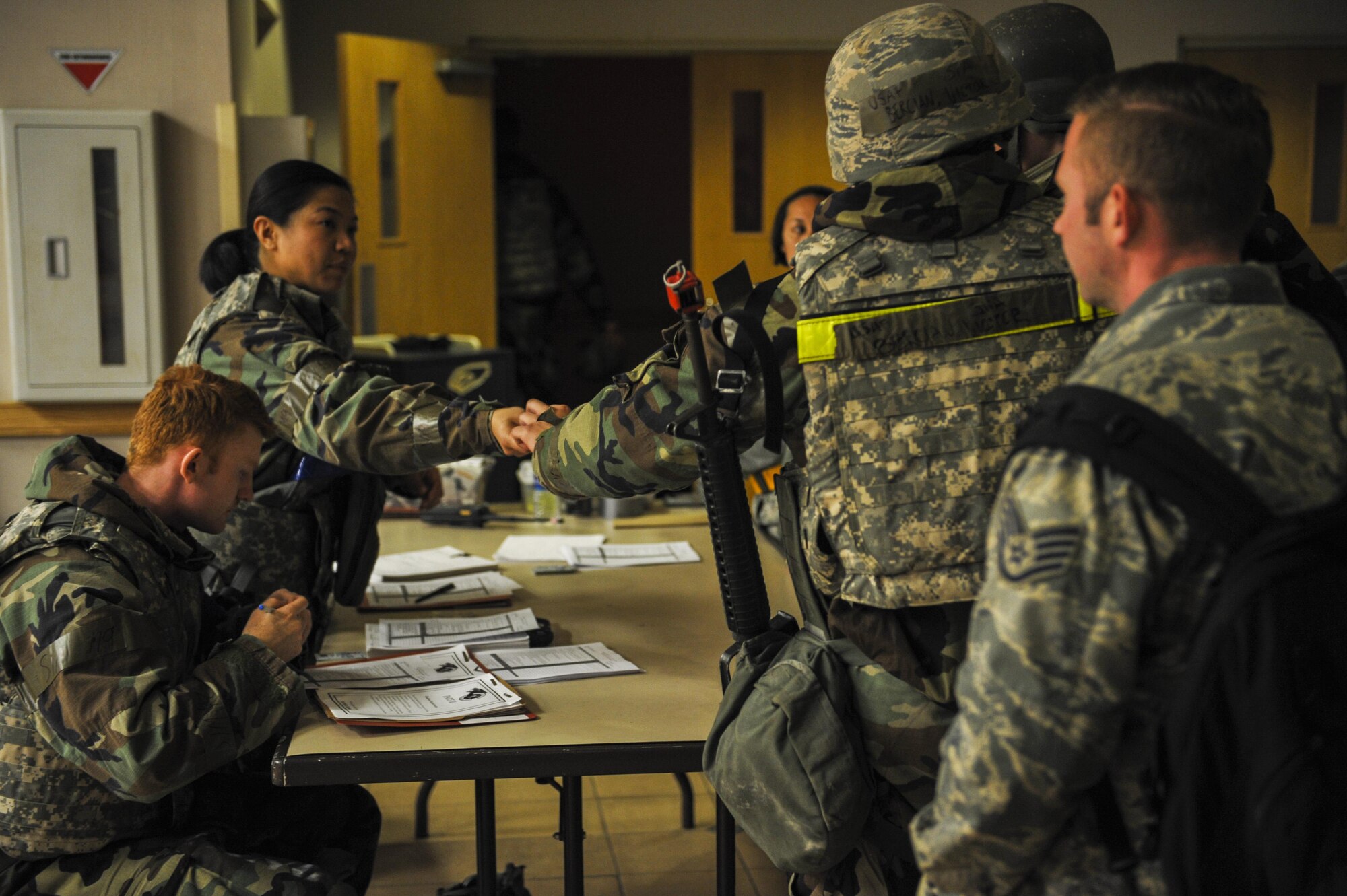 U.S. Air Force Senior Airman Dylan Williams and Staff Sgt. Toni Somera, 8th Force Support Squadron force management personalists, input information and collect identification as they accept follow-on forces during exercise Beverly Pack 17-2, a no-notice training exercise at Kunsan Air Base, Republic of Korea, March 8, 2017. Kunsan airmen provide combat capabilities alongside Republic of Korea partners by participating in training, inspections and exercises throughout the year to enhance communication and interoperability between military forces so they are prepared to fight as a combined force. (U.S. Air Force photo by Senior Airman Colville McFee/Released)