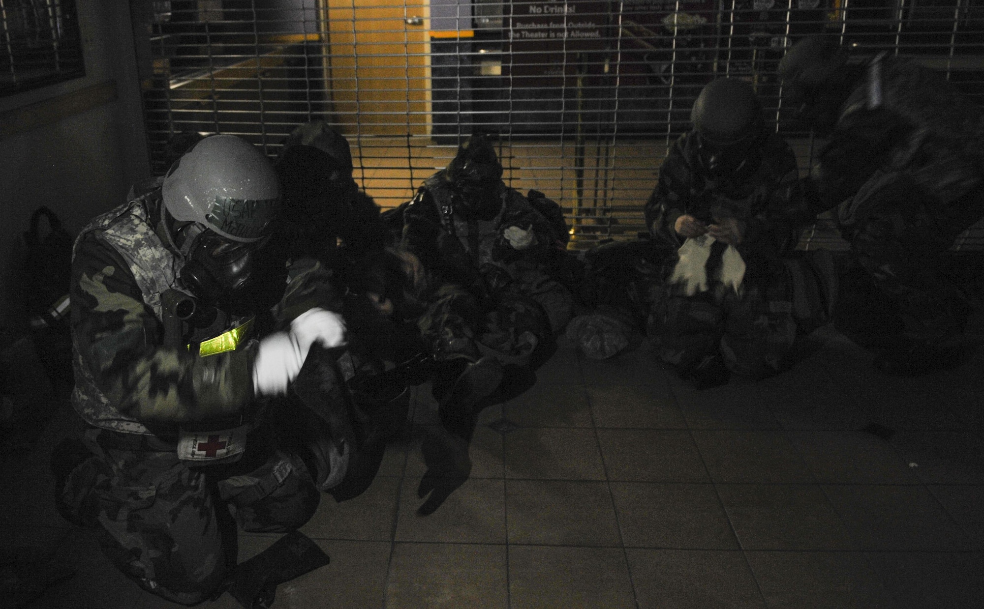 U.S. Air Force members take cover and don their protective gear in a simulated attack during exercise Beverly Pack 17-2, a no-notice training exercise at Kunsan Air Base, Republic of Korea, March 8, 2017. Kunsan airmen provide combat capabilities alongside Republic of Korea partners by participating in training, inspections and exercises throughout the year to enhance communication and interoperability between military forces so they are prepared to fight as a combined force. (U.S. Air Force photo by Senior Airman Colville McFee/Released)