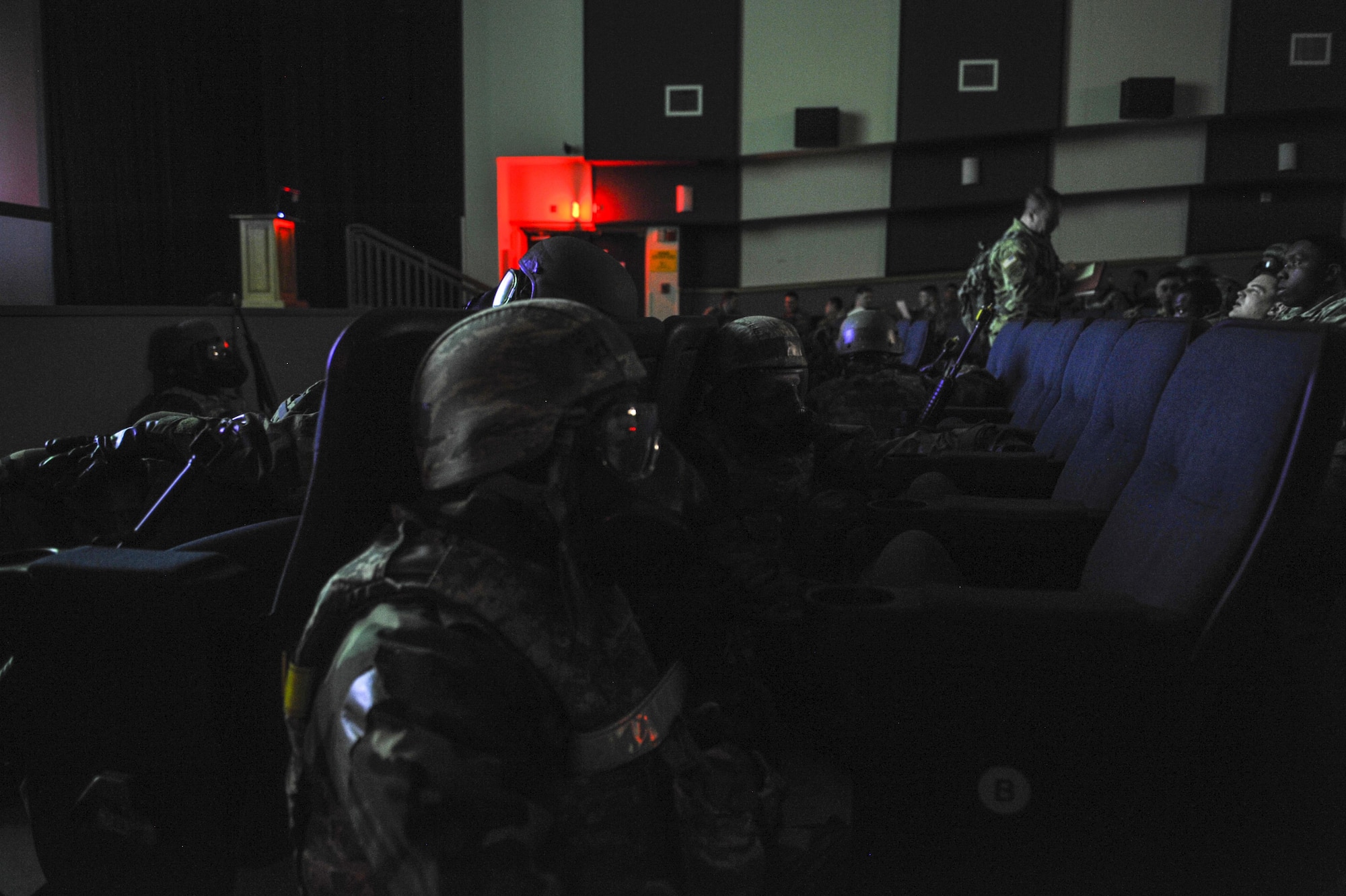 U.S. Air Force members take cover in protective gear in a simulated attack in the base theater during exercise Beverly Pack 17-2, a no-notice training exercise at Kunsan Air Base, Republic of Korea, March 8, 2017. Kunsan airmen provide combat capabilities alongside Republic of Korea partners by participating in training, inspections and exercises throughout the year to enhance communication and interoperability between military forces so they are prepared to fight as a combined force. (U.S. Air Force photo by Senior Airman Colville McFee/Released)