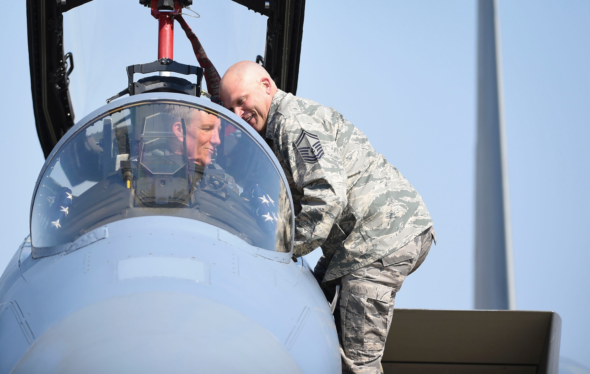 Photo of Gen. Herbert “Hawk” Carlisle, goes over a preflight maintenance check prior to his final flight