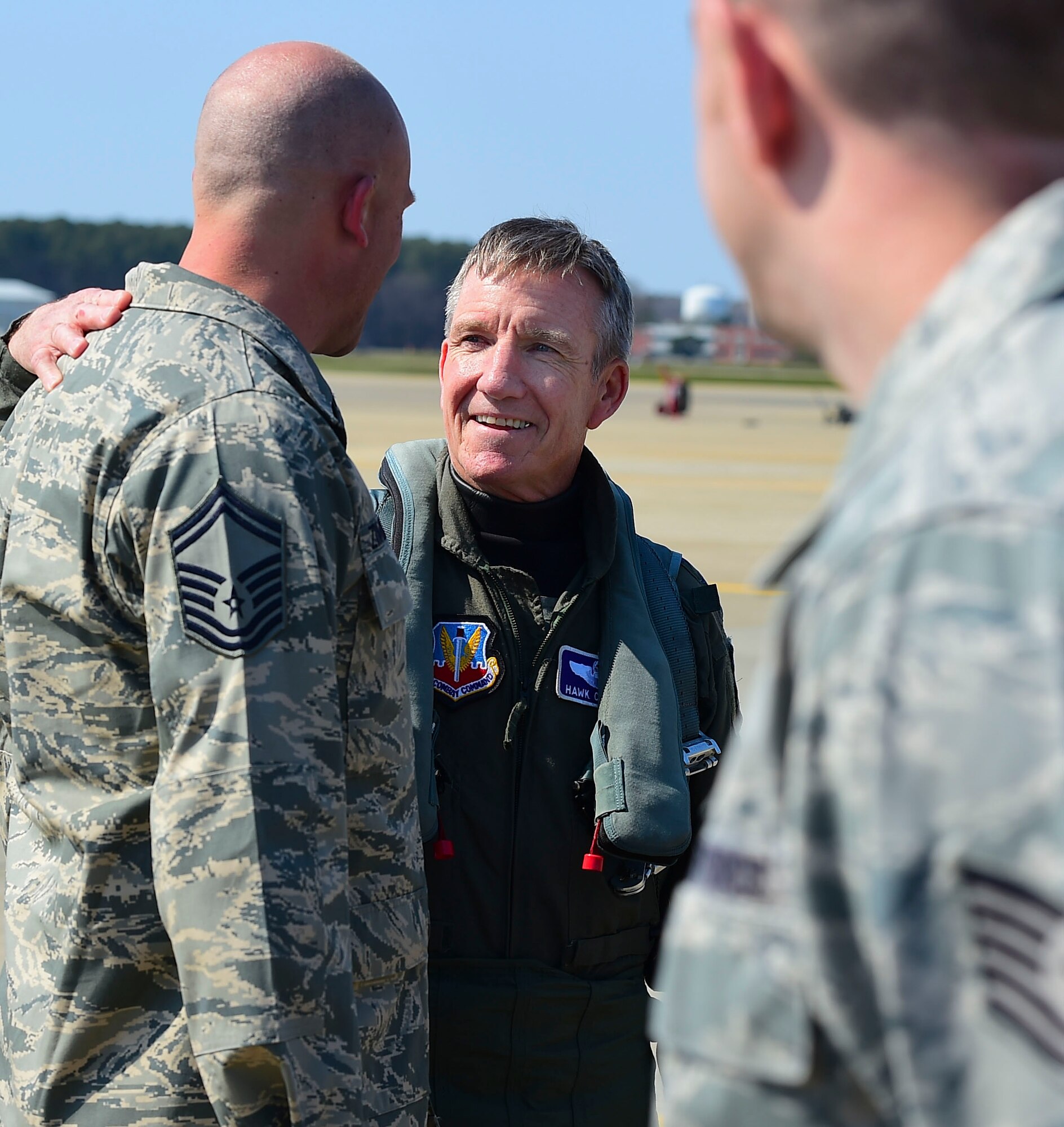 Photo of Gen. Herbert “Hawk” Carlisle, commander of Air Combat Command, greeting Senior Master Sgt. Jeffrey Zimmerman, his former crew chief before his final flight