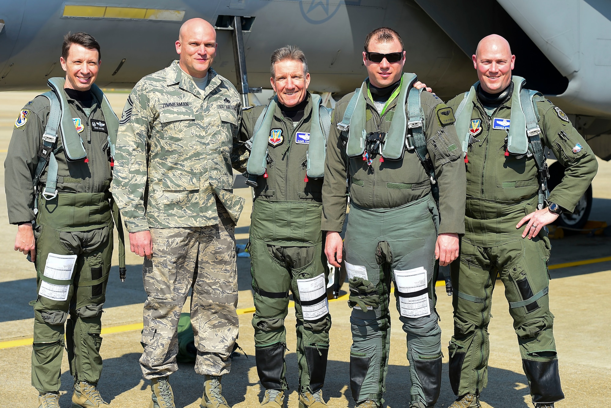 Photo of U.S. Air Force Gen. Herbert “Hawk” Carlisle,  with fellow pilots and his former crew chief, before his final flight