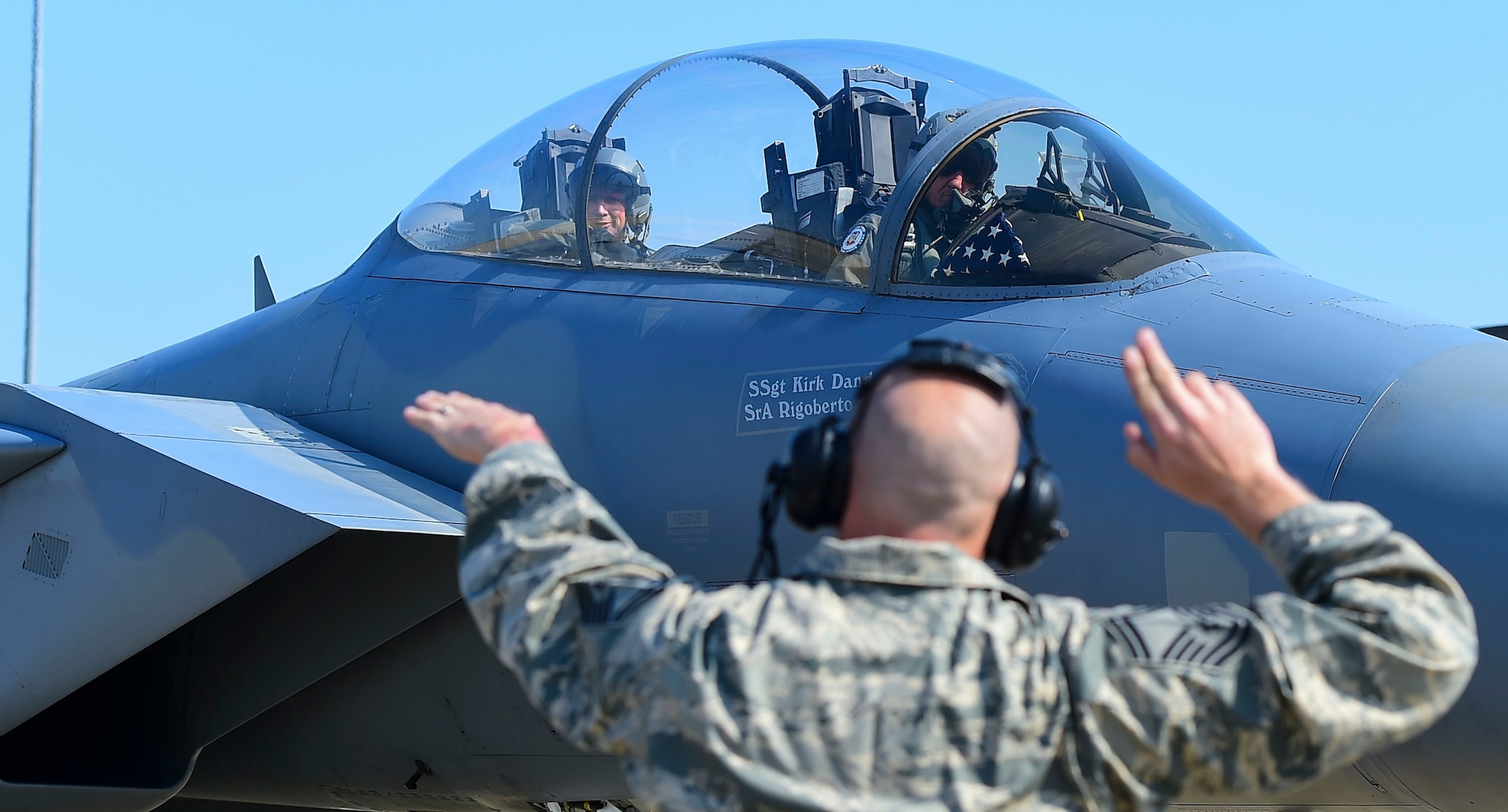 Photo of Senior Master Sgt. Jeffrey Zimmerman, guides Gen. Herbert “Hawk” Carlisle, as he prepares to takeoff on his final flight