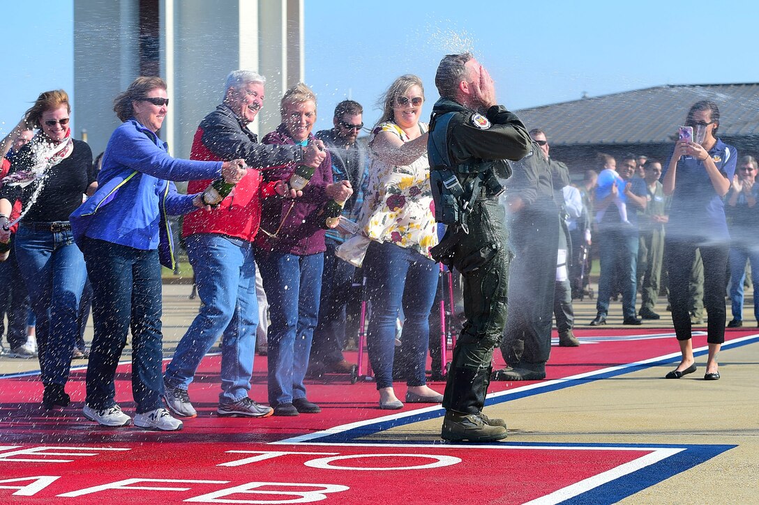 Photo of Gen. Herbert “Hawk” Carlisle, hosed down by his family and friends after taking his final flight