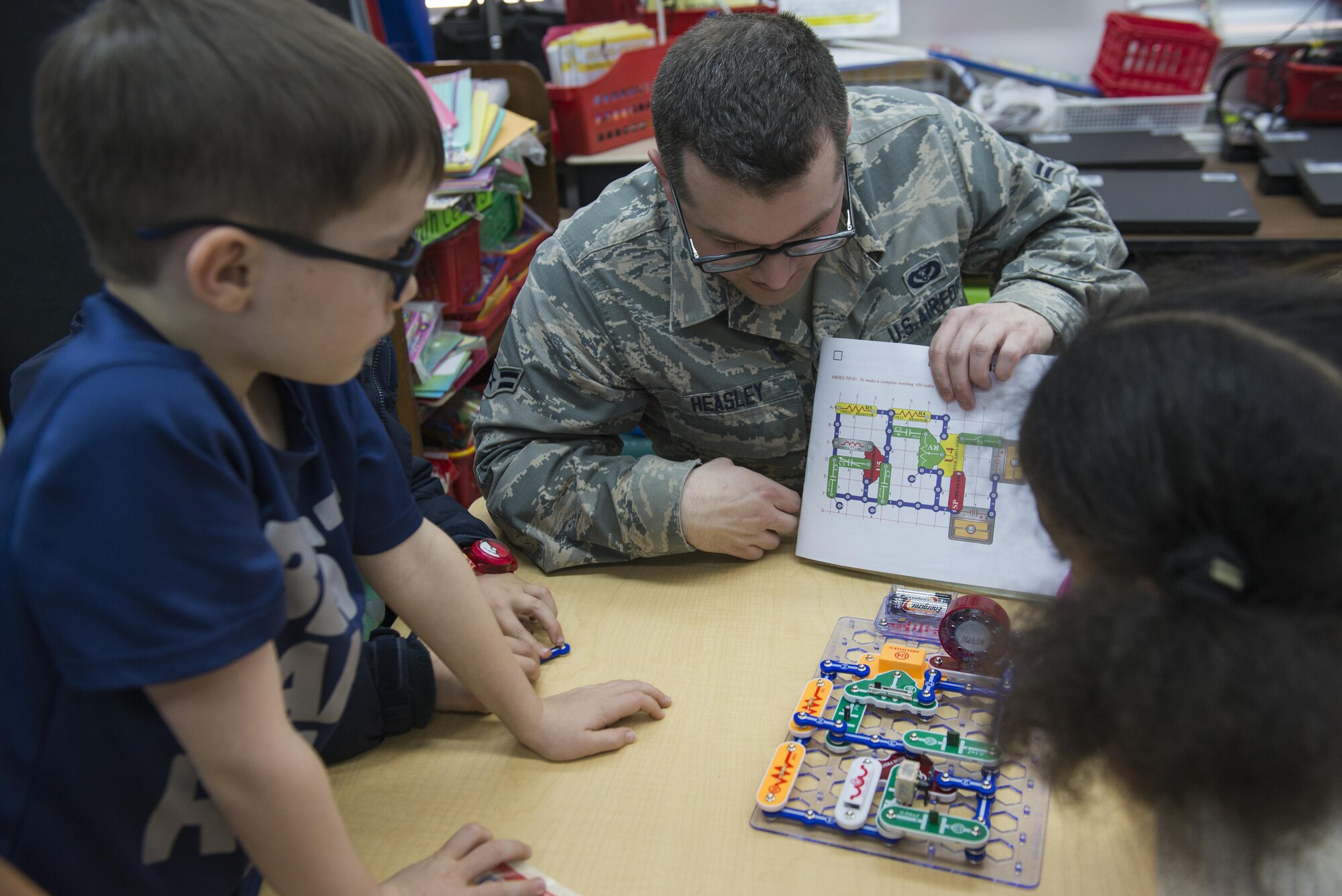 An airman with the 374th Civil Engineering Squadron’s Electric shop instructs students from Mendel Elementary School while they build a circuit during a Science, Technology, Engineering and Mathematics course March 9, 2017, at Yokota Air Base, Japan. During the course, students learn about electronic circuitry with the help of the 374 CES . (U.S. Air Force photo by Airman 1st Class Juan Torres)