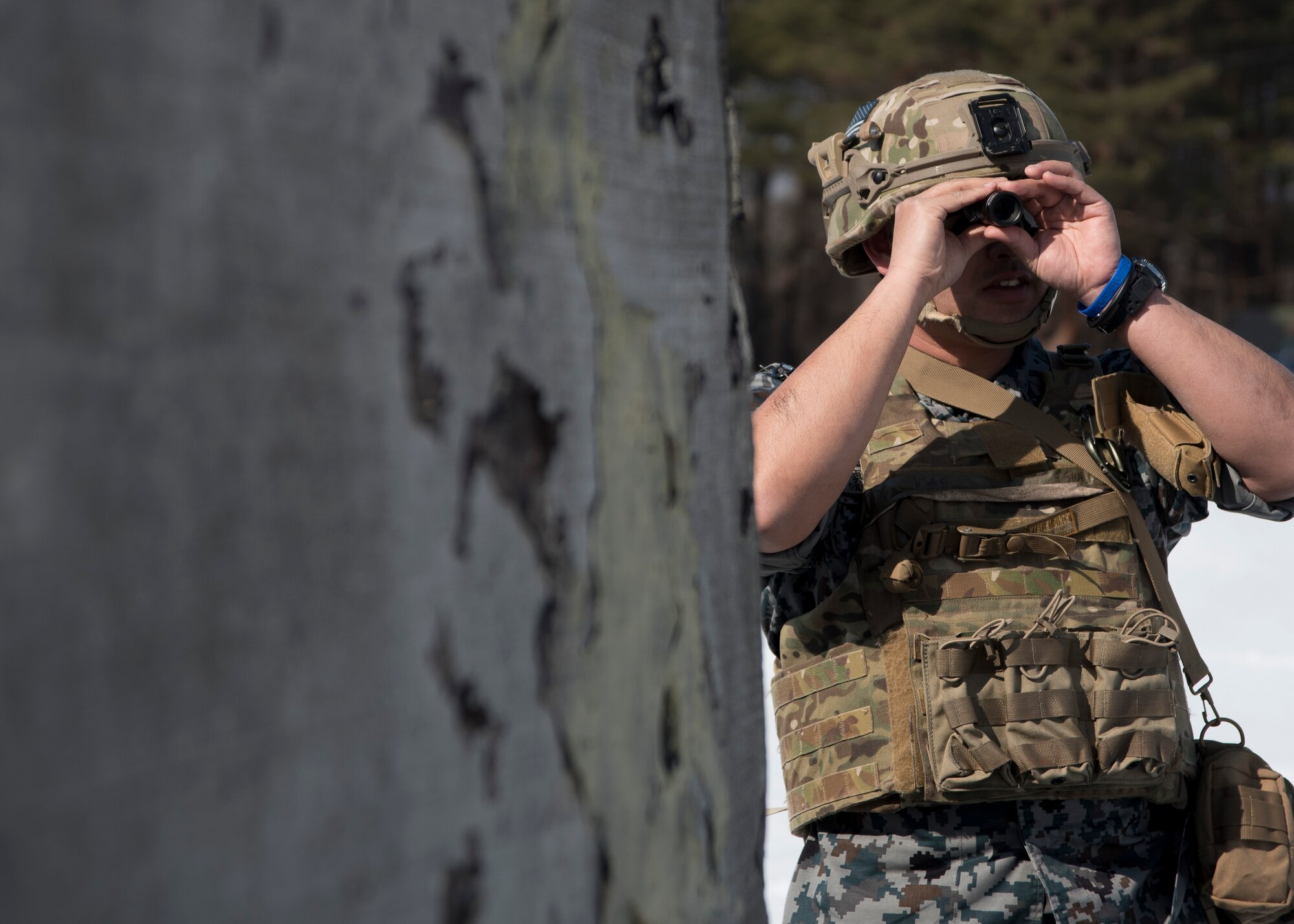 Japan Air Self-Defense Force Tech. Sgt. Shinji Okuzono, a Tohoku Explosive Ordnance Disposal school instructor, uses a laser range finder to get the accurate distance of the ordnance during a training scenario at Misawa Air Base, Japan, March 2, 2017. The laser range finder helped Okuzono confirm the type of ordnance and come up with a plan of approach to safely dismantle the ordnance. (U.S. Air Force photo by Staff Sgt. Melanie A. Hutto)