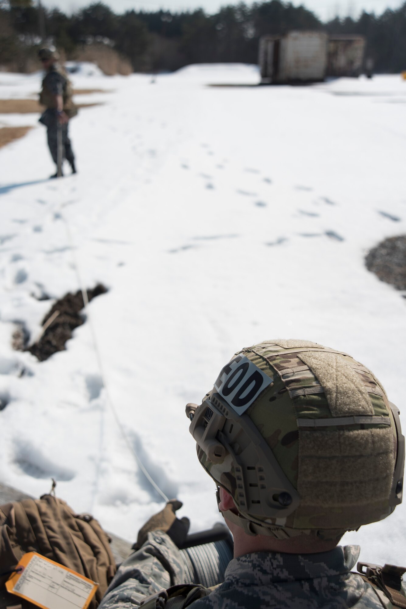 Japan Air Self-Defense Force Tech. Sgt. Shinji Okuzono, left, a Tohoku Explosive Ordnance Disposal school instructor, pulls a cord down range while U.S. Air Force Airman 1st Class Matthew Melendez, right, a 35th Civil Engineer Squadron EOD technicain, feeds it through the reel during a potential extraction training procedure at Misawa Air Base, Japan, March 2, 2017. There are a plethora of tools EOD technicians use to safely recover, diffuse and dispose of ordnance. (U.S. Air Force photo by Staff Sgt. Melanie A. Hutto)