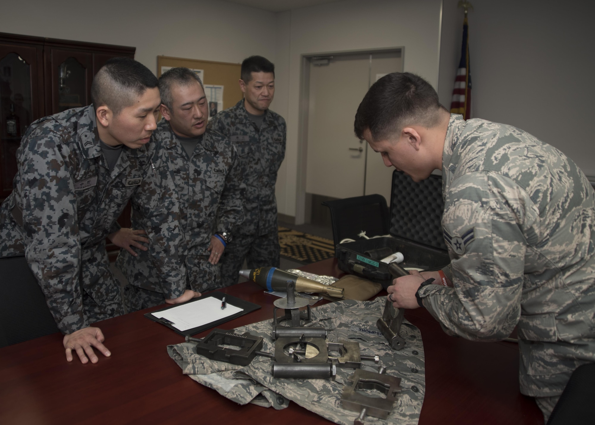 U.S. Air Force Airman 1st Class Matthew Melendez, right, 35th Civil Engineer Squadron explosive ordnance disposal technicain shows Japan Air Self-Defense Force Tohoku EOD school instructors, components of a variety of tools during the class room portion of a two-day training at Misawa Air Base, Japan, March 2, 2017. The training was based on building a mutual understanding of foundational EOD skills, to include classroom instruction and realistic hands-on practical exercises. (U.S. Air Force photo by Staff Sgt. Melanie A. Hutto)